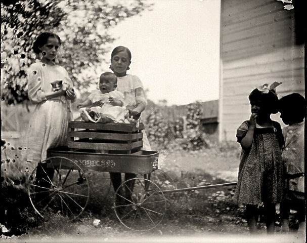 Herbert Henry Redhead on box in wagon, cousin Helen behind him