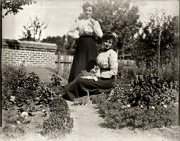 Aunt Jessie and Aunt Ollie by a root cellar with kitties